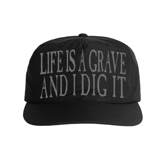Black unisex trucker cap with grey 'Life Is a Grave and I Dig It' text across the front..